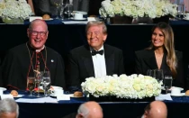 El presidente electo Donald Trump con su esposa Melania Trump y el Arzobispo de Nueva York, Cardenal Timothy M. Dolan (izquierda), asisten a la 79a cena anual de la Fundación Memorial Alfred E. Smith en el Hilton Midtown de la ciudad de Nueva York, el 17 de octubre de 2024.